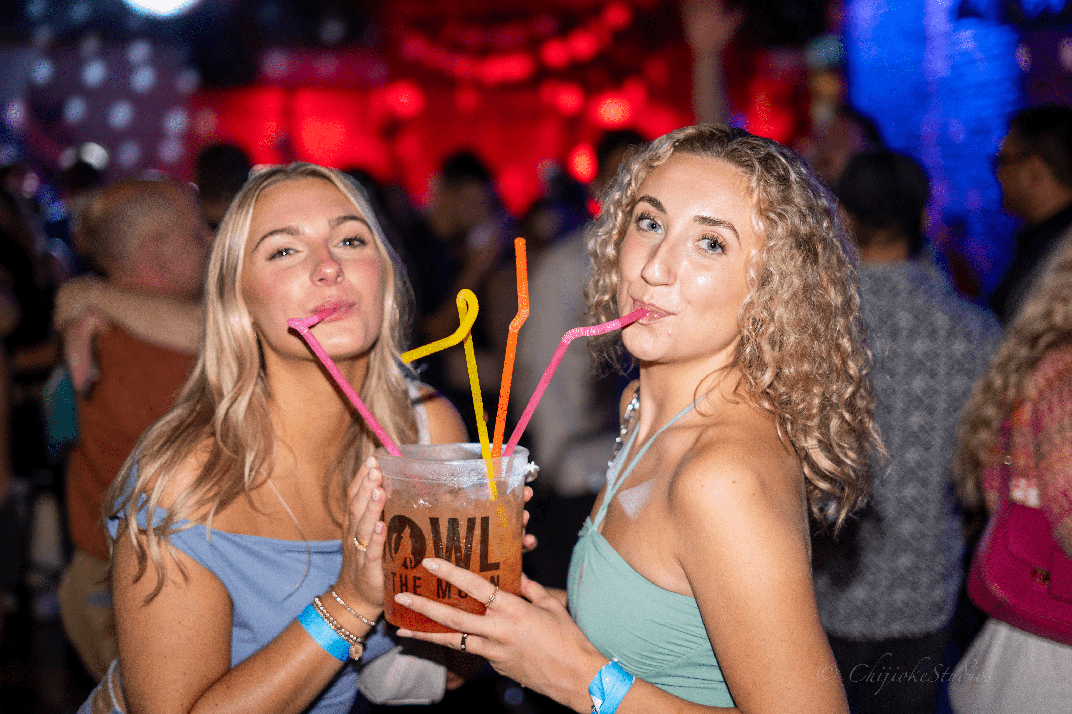 Girls drinking bucket cocktail