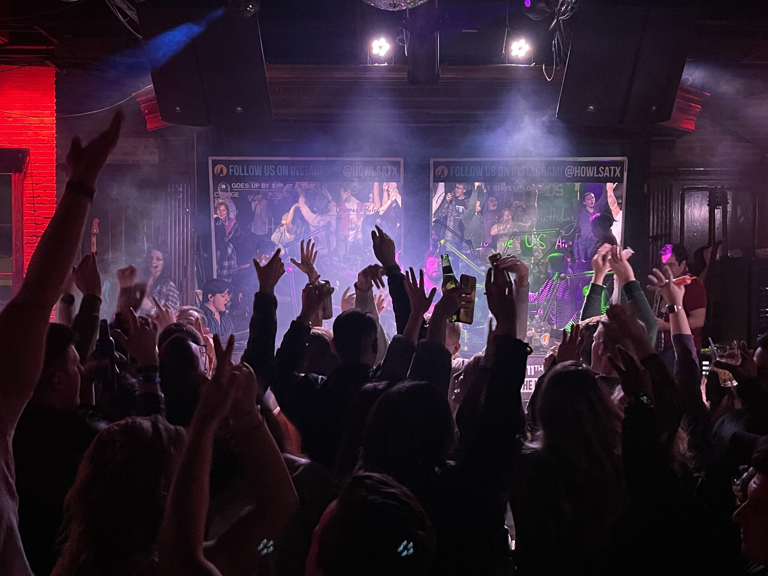 crowd of people listening to live music performance
