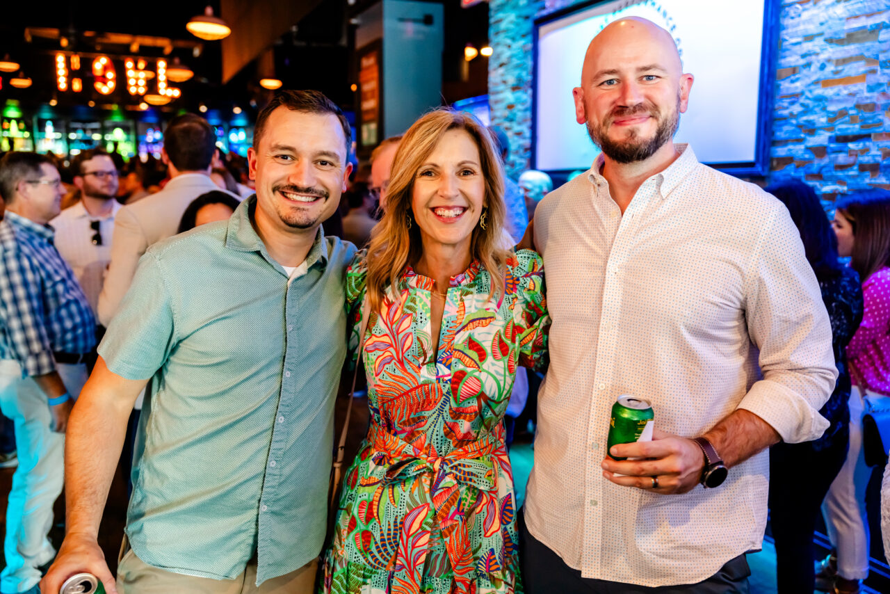 Three corporate workers at a party