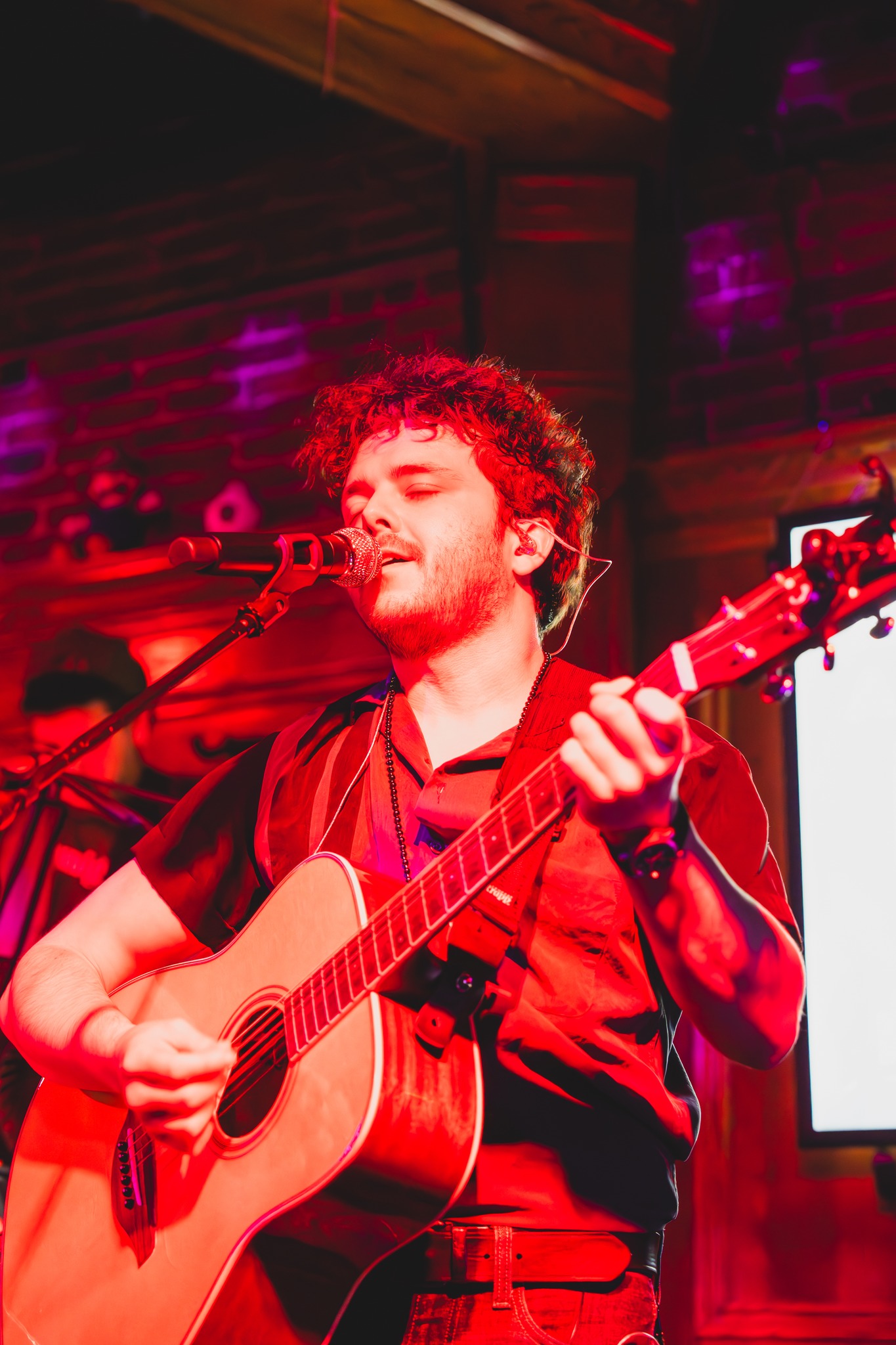 Boston entertainer on a night out playing guitar