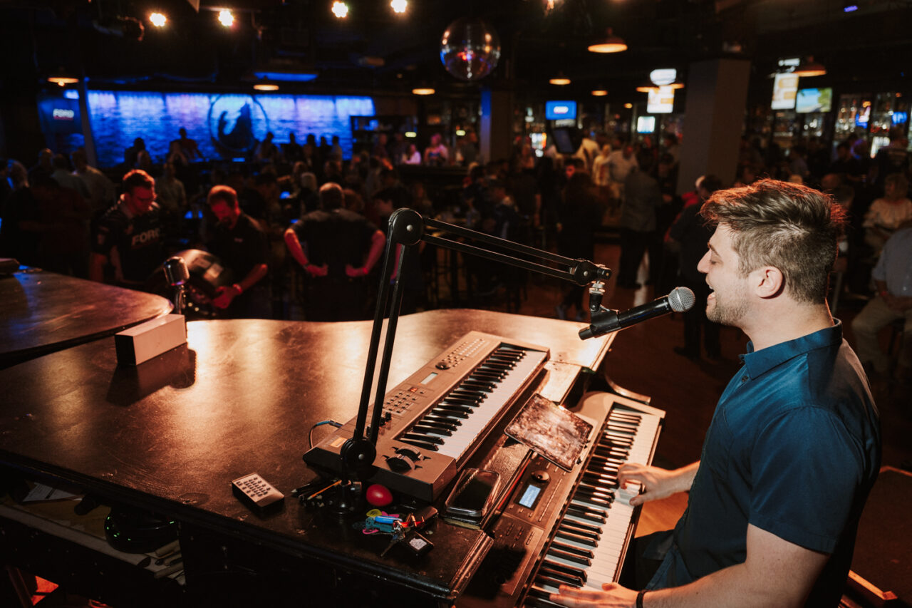 Male entertainer playing the piano on stage