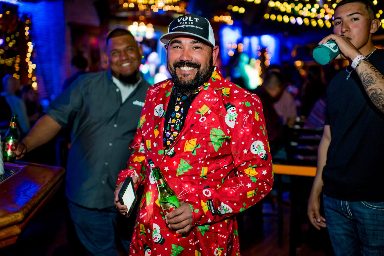Man wearing festive christmas jacket at holiday party