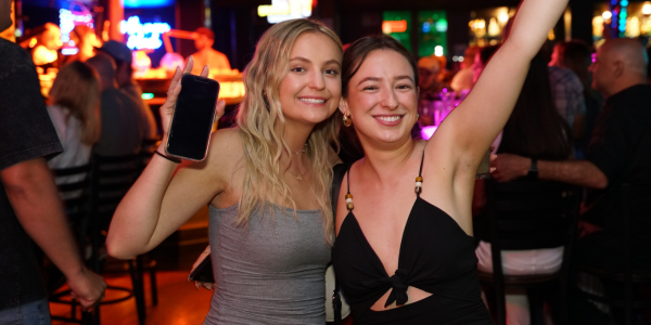Girls dancing and holding a phone