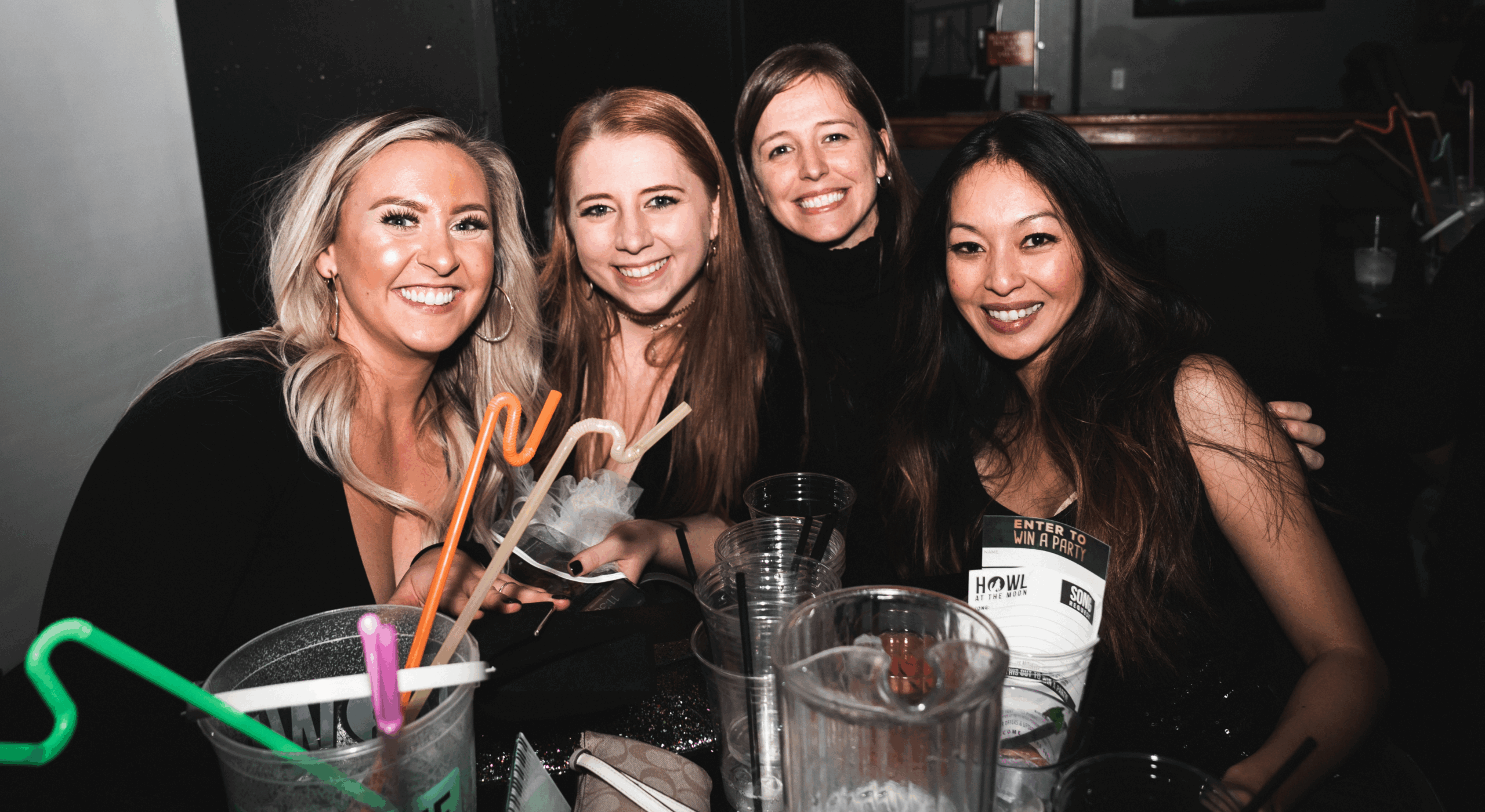 A group of people enjoying a performance while sitting at a reserved table