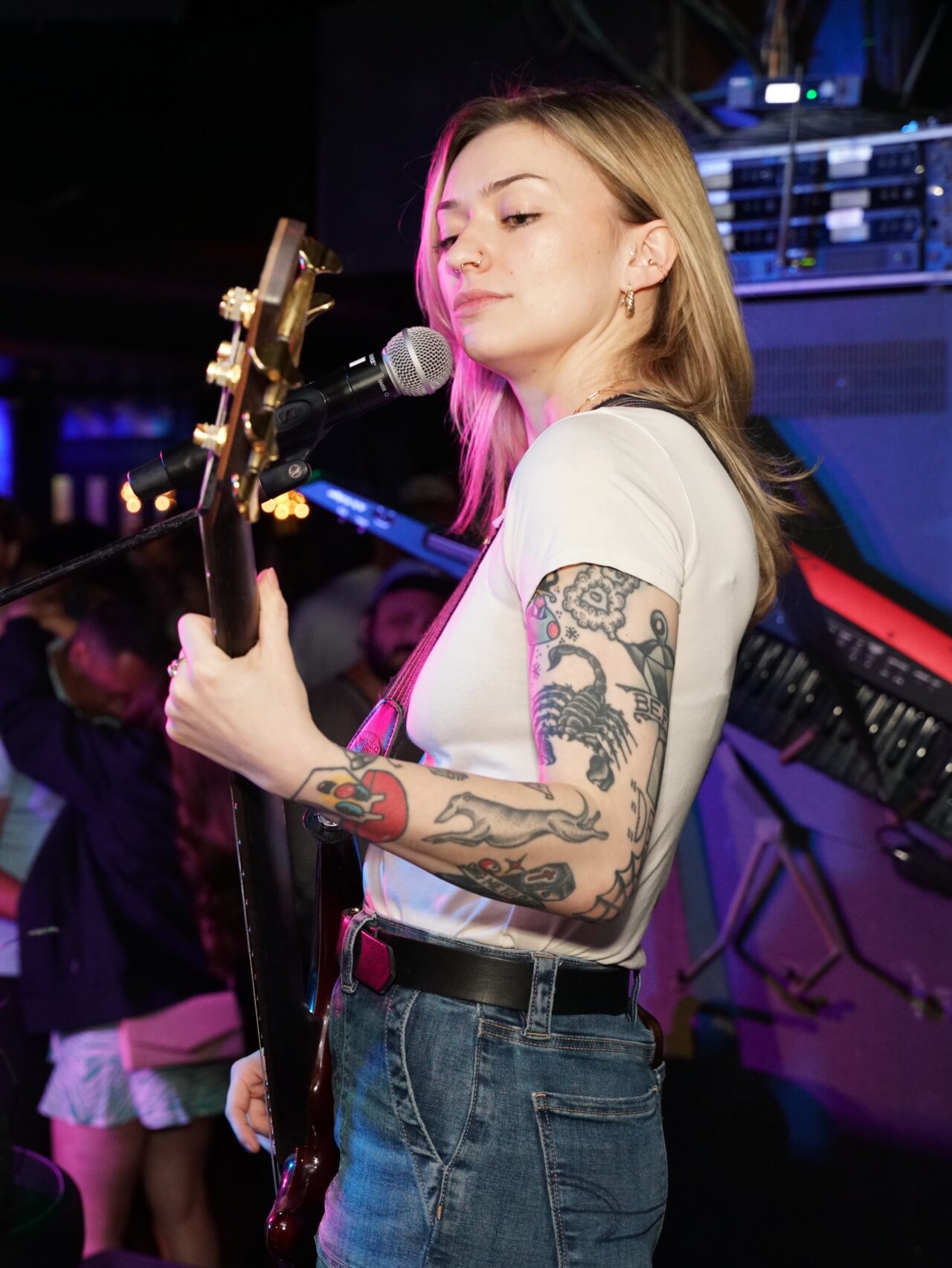 Female guitarist singing on stage at a Dad Rock Music Party featuring live classic rock and divorced dad rock music. Dad Rock Music Party.