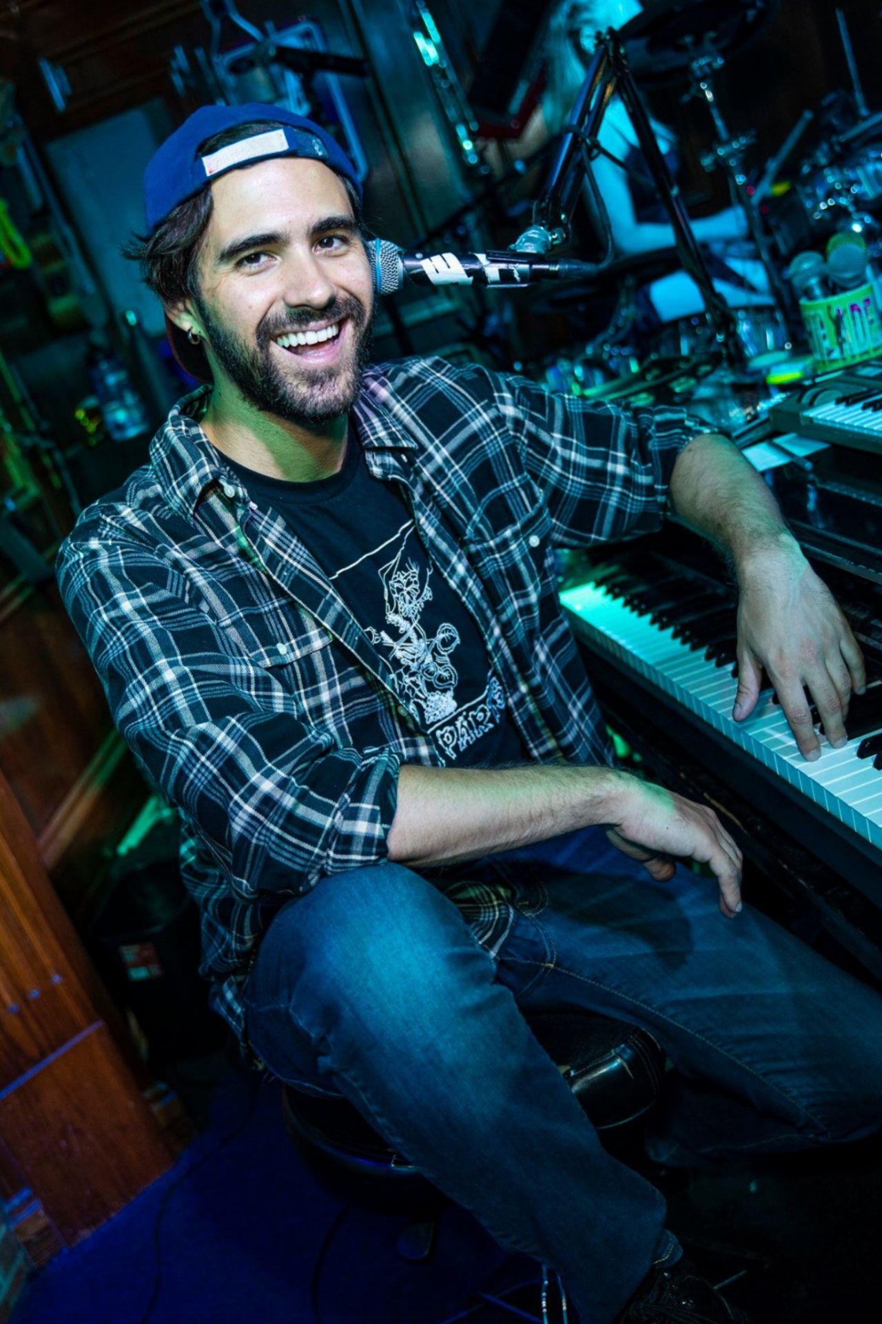 Smiling musician playing piano at a Dad Rock Music Party featuring live classic rock and divorced dad rock music. Dad Rock Music Party.