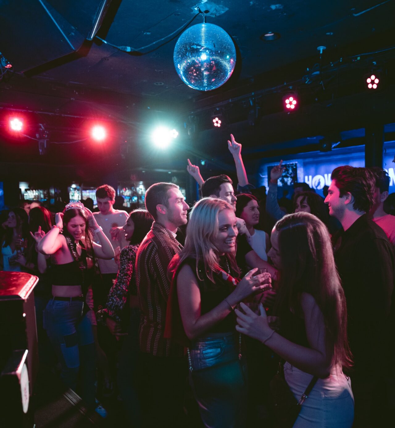 crowd dancing under disco ball at Movie Soundtrack Music Night live music event