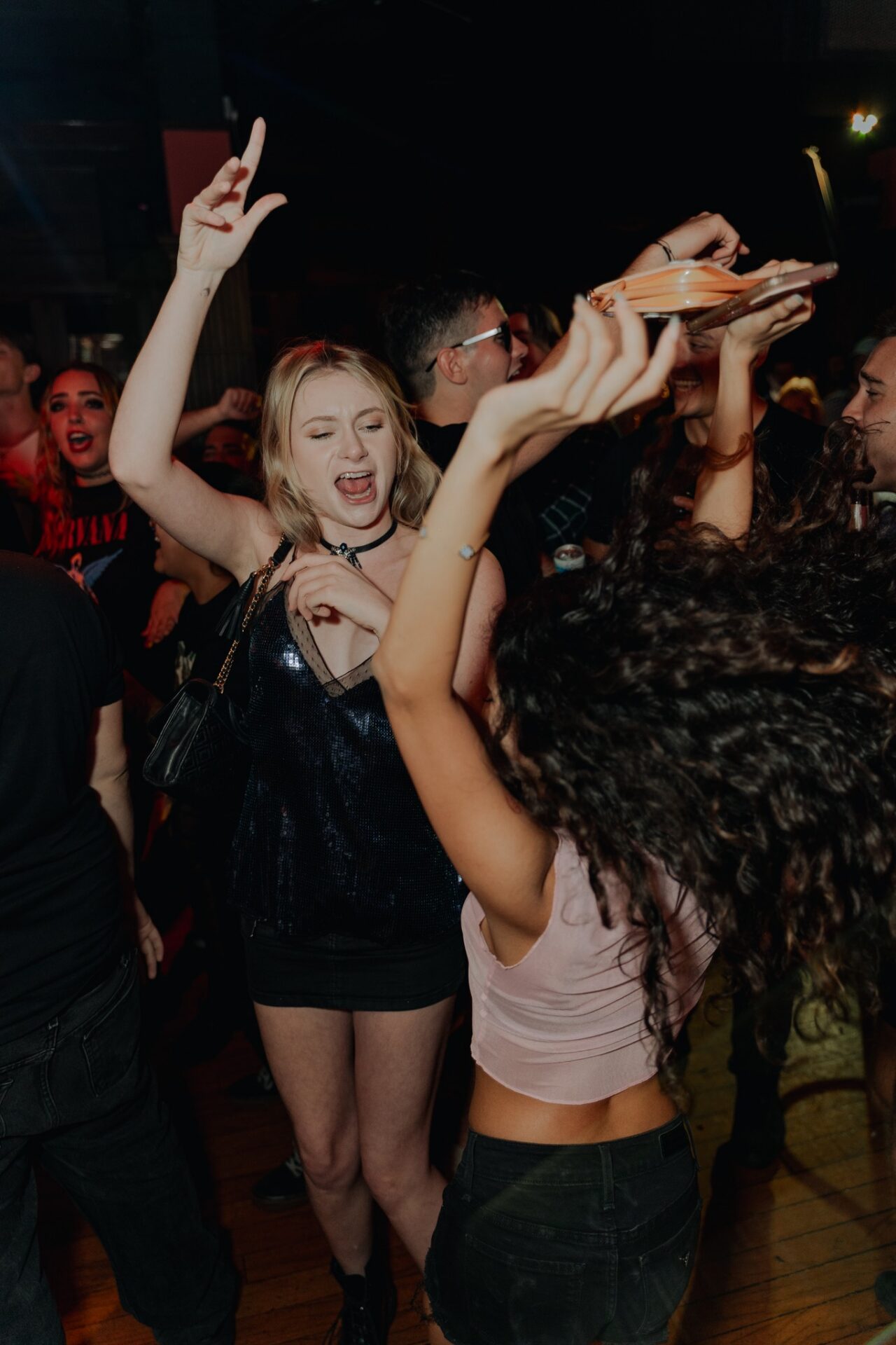 Guests dancing and celebrating on the dance floor during San Antonio Happy Hour.