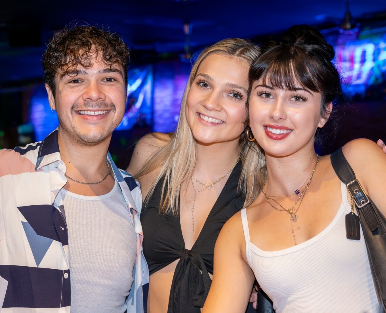 Guests posing together during Pittsburgh Happy Hour at Howl at the Moon.