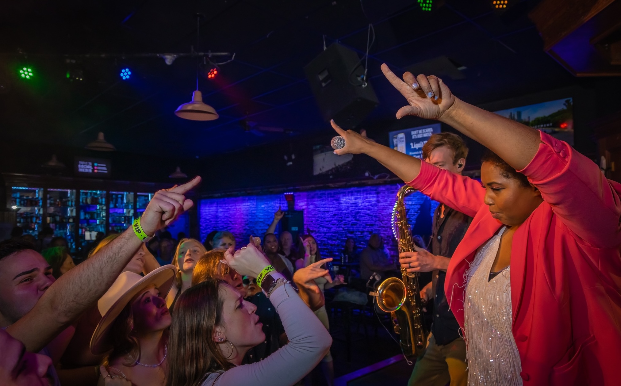 Guests singing and celebrating during Louisville Happy Hour at Howl at the Moon.