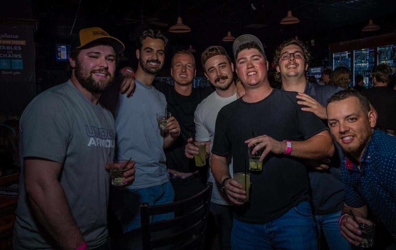 Group of friends enjoying drinks during Louisville Happy Hour at Howl at the Moon.