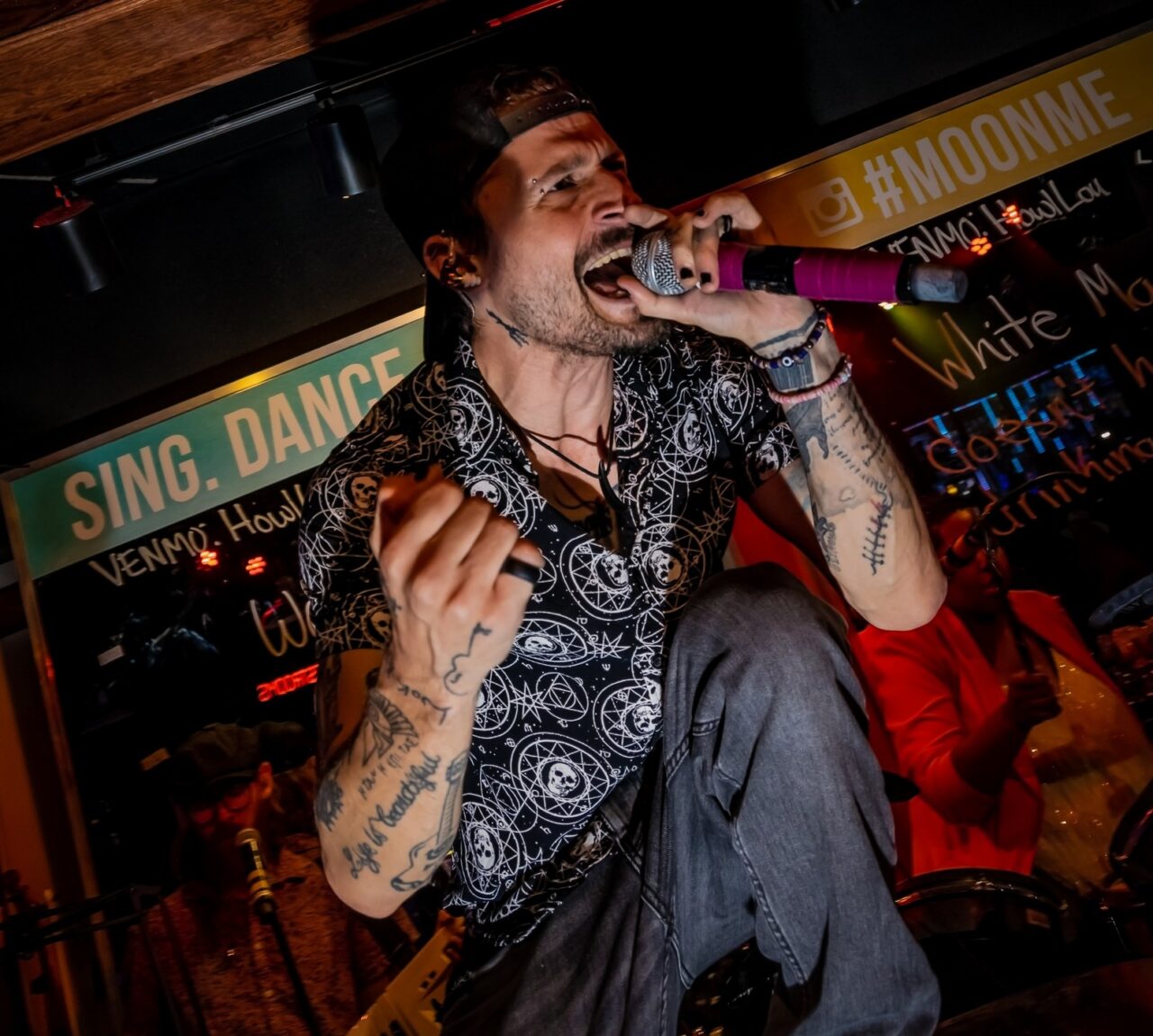 Live entertainer singing on stage during Louisville Happy Hour at Howl at the Moon.