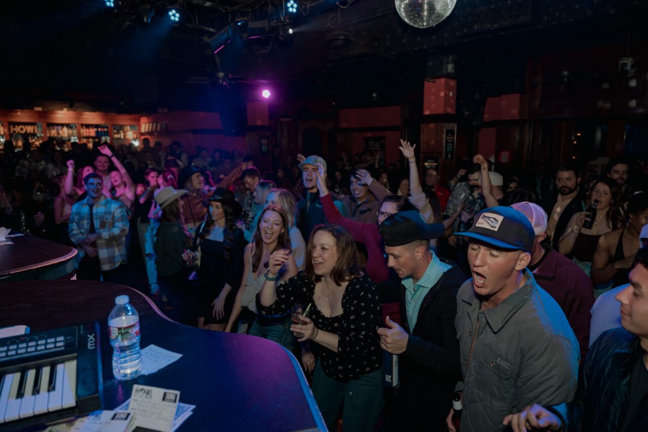 Guests singing and dancing near the stage during San Antonio Happy Hour at Howl at the Moon.