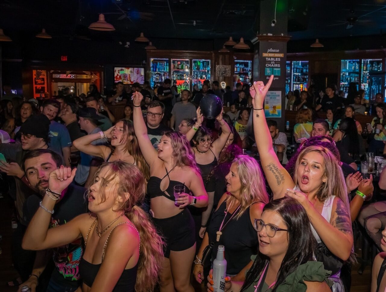 Guests dancing and singing during Louisville Happy Hour at Howl at the Moon.