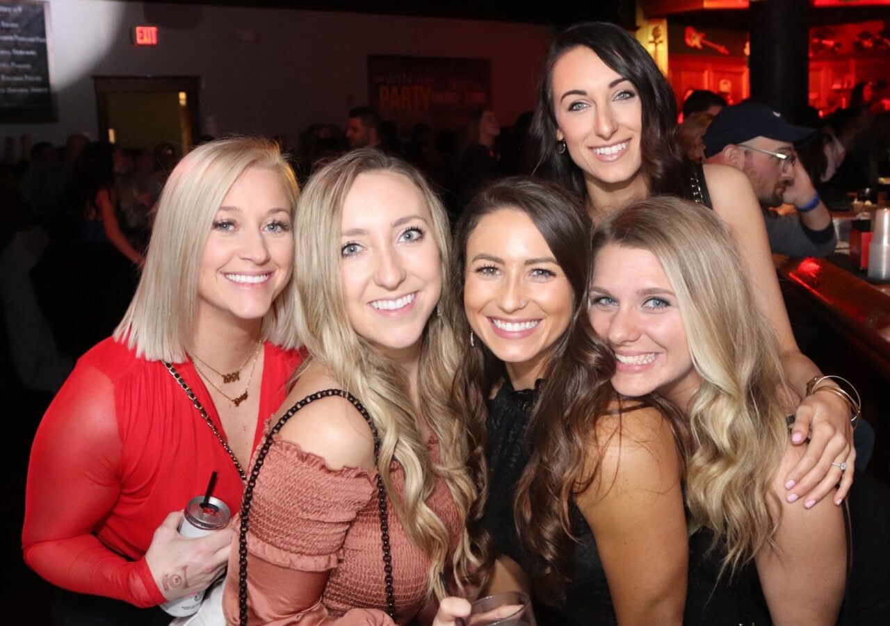Group of friends smiling together during Pittsburgh Happy Hour at Howl at the Moon.