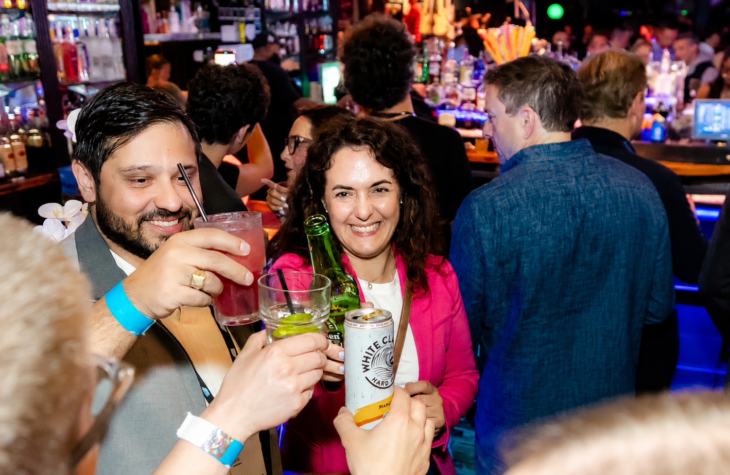 Guests raising drinks during Orlando Happy Hour at Howl at the Moon.