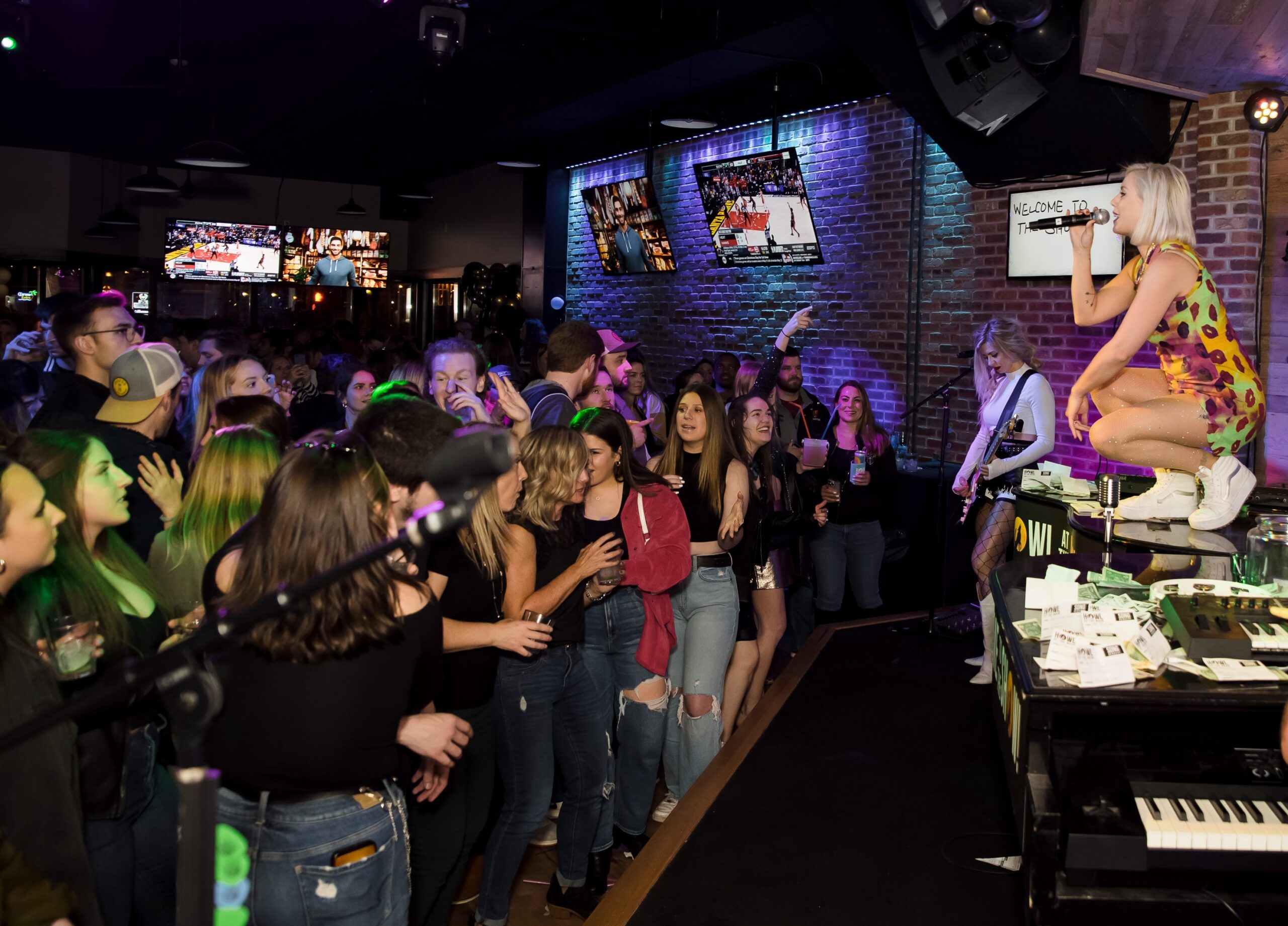 Guests enjoying live music and crowd interaction during the Boston Win a Party promotion at Howl at the Moon.