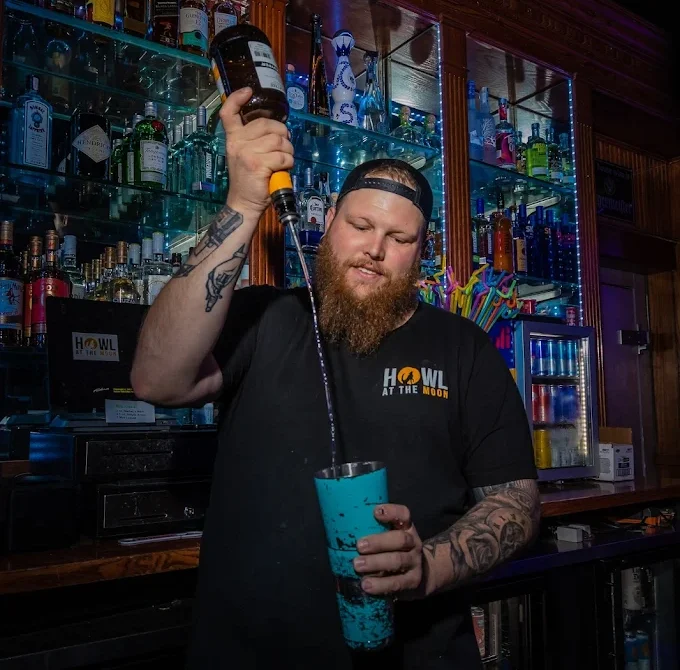 Bartender preparing a signature drink during Kansas City Happy Hour at Howl at the Moon.