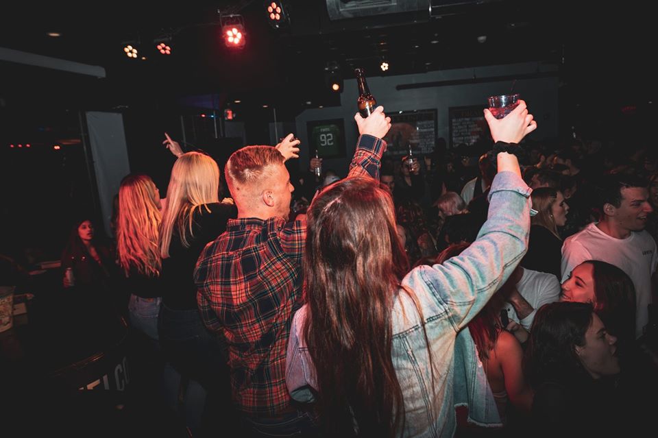 Crowd does a beer cheers at Dad Rock party night